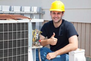 A technician inspecting the outdoor unit of a home heat pump system in a backyard.